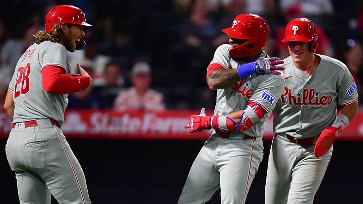 Aug 28, 2026; Anaheim, California, USA; Philadelphia Phillies left fielder Edmundo Sosa (33) is greeted by catcher J.T. Realmuto (10) and third baseman Alec Bohm (28) after hitting a grand slam home run against the Los Angeles Angels during the ninth inning at Angel Stadium. Mandatory Credit: Gary A. Vasquez-Imagn Images