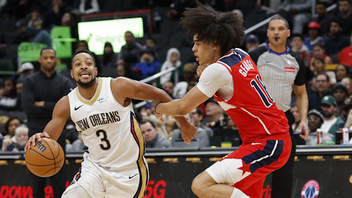Jan 5, 2025; Washington, District of Columbia, USA; New Orleans Pelicans guard CJ McCollum (3) drives to the basket as Washington Wizards forward Kyshawn George (18) defends in the fourth quarter at Capital One Arena. Mandatory Credit: Geoff Burke-Imagn Images