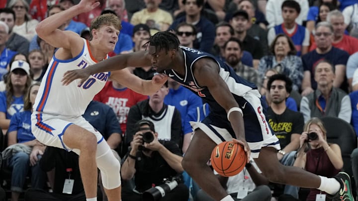 Nov 3, 2025; Las Vegas, NV, USA; Florida Gators forward Thomas Haugh (10) defends Arizona Wildcats guard Dwayne Aristode (2) in the first half of the Hall of Fame Series game at T-Mobile Arena. Mandatory Credit: Candice Ward-Imagn Images