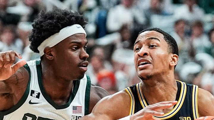Michigan guard Nimari Burnett dribbles against Michigan State forward Coen Carr during the first half at Breslin Center in East Lansing on Sunday, March 9, 2025.