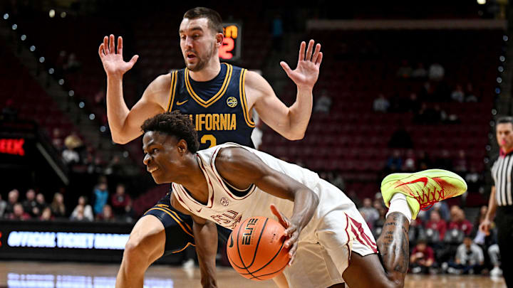 Jan 28, 2026; Tallahassee, Florida, USA; Florida State Seminoles forward Thomas Bassong (3) drives to the net past the defense of California Golden Bears forward John Camden (2) during the first half at Donald L. Tucker Center. Mandatory Credit: Melina Myers-Imagn Images