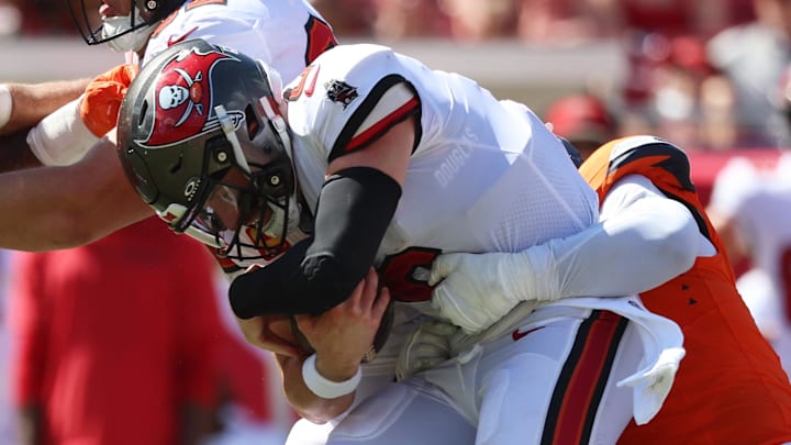 Sep 22, 2024; Tampa, Florida, USA; Denver Broncos linebacker Jonathon Cooper (0) sacks Tampa Bay Buccaneers quarterback Baker Mayfield (6) during the second half at Raymond James Stadium. Mandatory Credit: Kim Klement Neitzel-Imagn Images