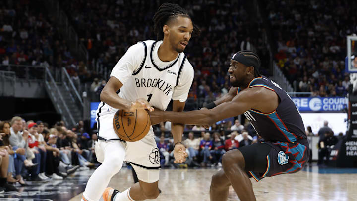 Mar 7, 2026; Detroit, Michigan, USA;  Brooklyn Nets forward Ziaire Williams (1) dribbles defended by Detroit Pistons guard Caris LeVert (8) in the first half at Little Caesars Arena. Mandatory Credit: Rick Osentoski-Imagn Images