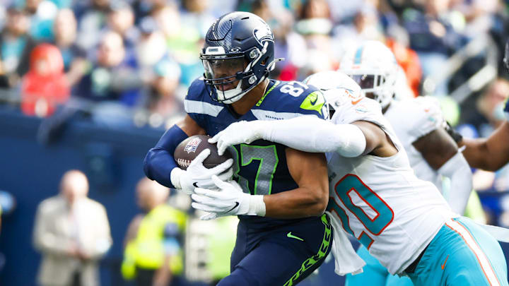 Sep 22, 2024; Seattle, Washington, USA; Seattle Seahawks tight end Noah Fant (87) runs for yards after the catch against Miami Dolphins linebacker Jordyn Brooks (20) during the third quarter at Lumen Field. Mandatory Credit: Joe Nicholson-Imagn Images