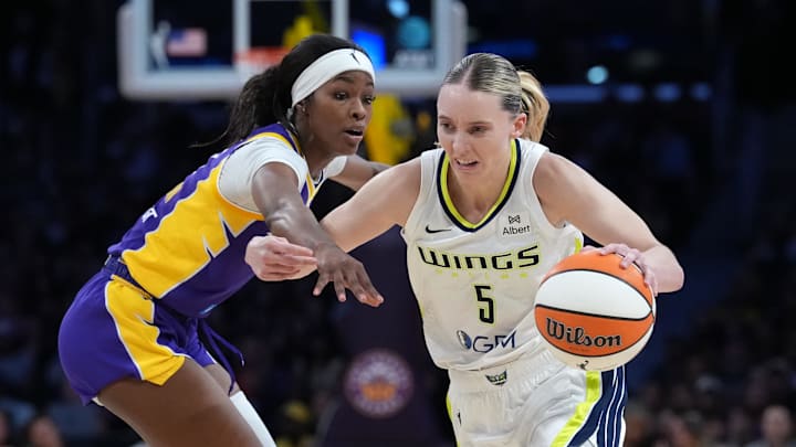 Aug 20, 2025; Los Angeles, California, USA; Dallas Wings guard Paige Bueckers (5) dribbles against LA Sparks forward Rickea Jackson (2) in the first half at Crypto.com Arena. Mandatory Credit: Kirby Lee-Imagn Images