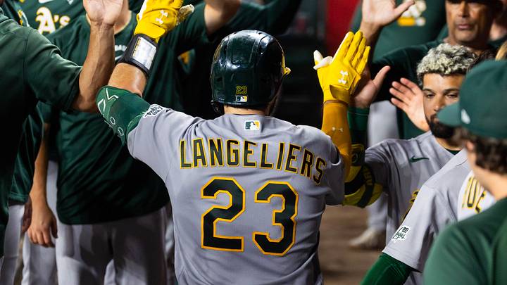 Jul 21, 2026; Phoenix, Arizona, USA; Athletics catcher Shea Langeliers (23) celebrates with teammates in the dugout after hitting a solo home run in the eighth inning against the Arizona Diamondbacks at Chase Field. Mandatory Credit: Mark J. Rebilas-Imagn Images Jul 21, 2026; Phoenix, Arizona, USA; Athletics catcher Shea Langeliers (23) celebrates with teammates in the dugout after hitting a solo home run in the eighth inning against the Arizona Diamondbacks at Chase Field. Mandatory Credit: Mark J. Rebilas-Imagn Images