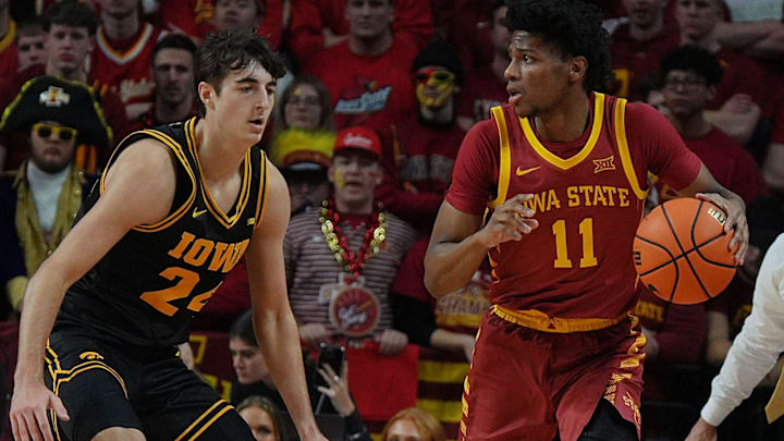 Iowa State Cyclones guard Dominick Nelson (11) drives with the ball around Iowa Hawkeyes guard Tate Sage (24) during the first half in the men’s basketball Cy-Hawk series on Dec. 11, 2025, in Ames, Iowa.