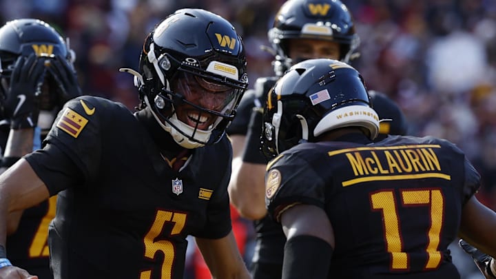 Dec 1, 2024; Landover, Maryland, USA; Washington Commanders wide receiver Terry McLaurin (17) and Commanders quarterback Jayden Daniels (5) celebrate after connecting on a touchdown pass against the Tennessee Titans during the first quarter at Northwest Stadium. Mandatory Credit: Geoff Burke-Imagn Images