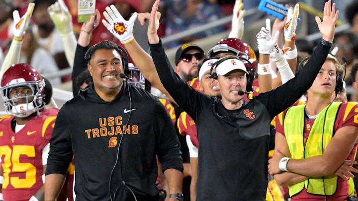 Oct 11, 2025; Los Angeles, California, USA; USC Trojans head coach Lincoln Riley (wearing white visor) celebrates along with defensive end coach Shaun Nua after kicker Ryon Sayeri (48) hit a 54-yard field goal in the second half against the Michigan Wolverines at United Airlines Field at the Los Angeles Memorial Coliseum. Mandatory Credit: Jayne Kamin-Oncea-Imagn Images Oct 11, 2025; Los Angeles, California, USA; USC Trojans head coach Lincoln Riley (wearing white visor) celebrates along with defensive end coach Shaun Nua after kicker Ryon Sayeri (48) hit a 54-yard field goal in the second half against the Michigan Wolverines at United Airlines Field at the Los Angeles Memorial Coliseum. Mandatory Credit: Jayne Kamin-Oncea-Imagn Images