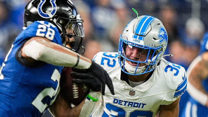Indianapolis Colts running back Jonathan Taylor (28) runs against Detroit Lions safety Brian Branch (32) 