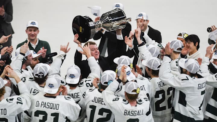 MSU hockey coach Adam Nightingale hoists up the Big Ten Championship trophy after the Spartans beat U-M 5-4 in an overtime thriller, Saturday, March 23, 2024, during the first period of the Big Ten hockey championship at Munn Ice Arena in East Lansing.