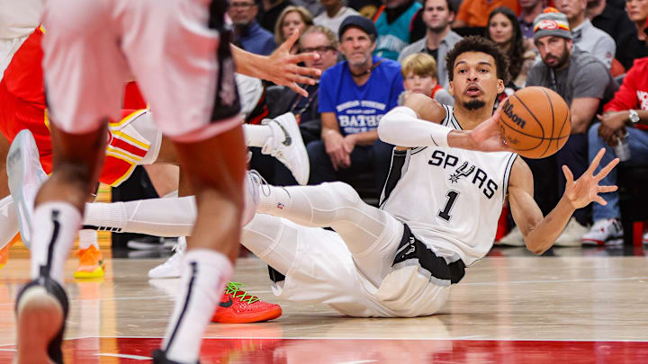 Feb 5, 2025; Atlanta, Georgia, USA; San Antonio Spurs center Victor Wembanyama (1) passes after controlling a loose ball against the Atlanta Hawks in the first quarter at State Farm Arena.