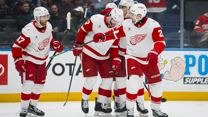 Dec 8, 2025; Vancouver, British Columbia, CAN; Detroit Red Wings defenseman Ben Chiarot (8) and forward Michael Rasmussen (27) and forward J.T. Compher (37) and forward James van Riemsdyk (21) celebrate Riemsdyk’s goal against the Vancouver Canucks in the first period at Rogers Arena. Mandatory Credit: Bob Frid-Imagn Images