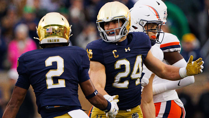 Notre Dame safety Rod Heard II (2) and linebacker Jack Kiser (24) celebrate getting a stop during a NCAA college football game against Virginia at Notre Dame Stadium on Saturday, Nov. 16, 2024, in South Bend.