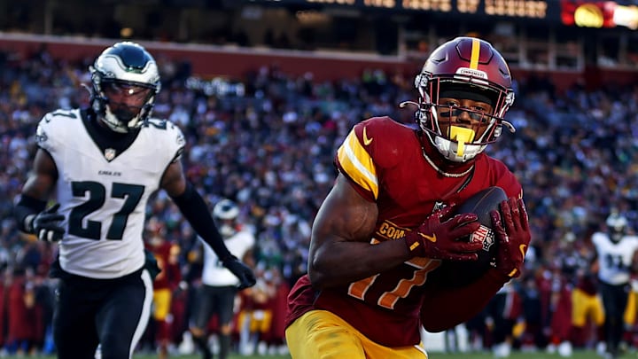 Dec 22, 2024; Landover, Maryland, USA; Washington Commanders wide receiver Terry McLaurin (17) catches a touchdown pass against Philadelphia Eagles cornerback Quinyon Mitchell (27) during the second quarter at Northwest Stadium. Dec 22, 2024; Landover, Maryland, USA; Washington Commanders wide receiver Terry McLaurin (17) catches a touchdown pass against Philadelphia Eagles cornerback Quinyon Mitchell (27) during the second quarter at Northwest Stadium.