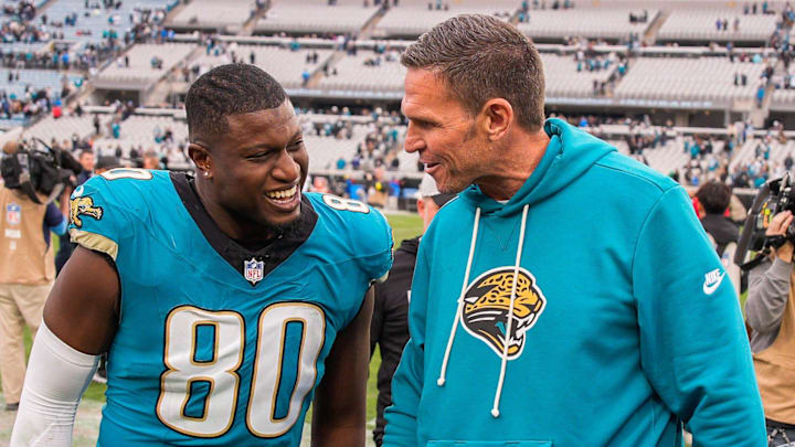 Jacksonville Jaguars tight end Quintin Morris (80) has a laugh with Jacksonville Jaguars Executive Vice President of Football Operations Tony Boselli after the game at EverBank Stadium, Sunday, Jan. 4, 2026, in Jacksonville, Fla. The Jaguars defeated the Titans 41-7 [Doug Engle/Florida Times-Union]