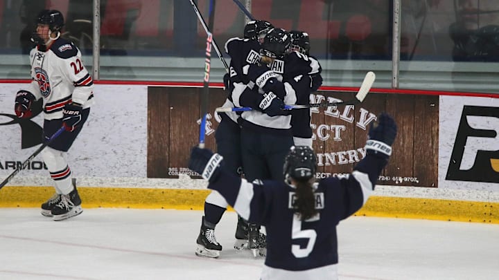 Penn State women's hockey celebrating scoring a goal with teammates.