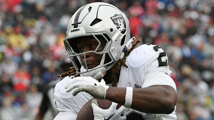 Sep 7, 2025; Foxborough, Massachusetts, USA; Las Vegas Raiders running back Ashton Jeanty (2) rushes the ball against the New England Patriots during he second half at Gillette Stadium. Mandatory Credit: Bob DeChiara-Imagn Images