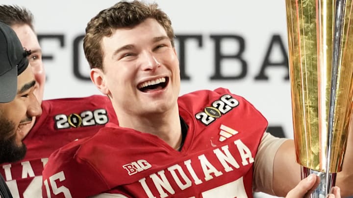 Jan 19, 2026; Miami Gardens, FL, USA; Indiana Hoosiers quarterback Fernando Mendoza (15) lifts the trophy after the College Football Playoff National Championship game against the Miami Hurricanes at Hard Rock Stadium. Mandatory Credit: Kirby Lee-Imagn Images