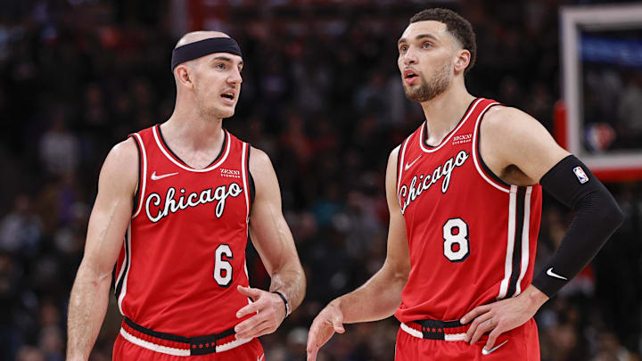 Mar 31, 2022; Chicago, Illinois, USA; Chicago Bulls guard Alex Caruso (6) talks with guard Zach