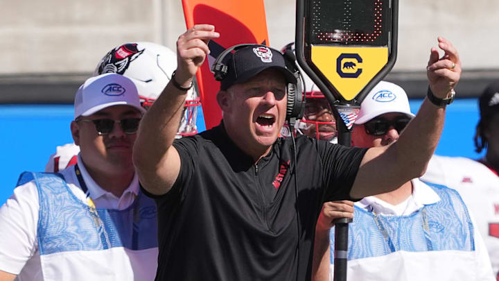 Oct 19, 2024; Berkeley, California, USA; North Carolina State Wolfpack head coach Dave Doeren (center) yells during the second quarter against the California Golden Bears at California Memorial Stadium. Mandatory Credit: Darren Yamashita-Imagn Images