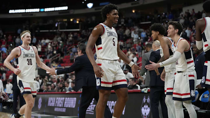 Mar 21, 2025; Raleigh, NC, USA;  Connecticut Huskies celebrate the win against Oklahoma Sooners at Lenovo Center. Mandatory Credit: Bob Donnan-Imagn Images