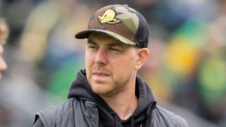 Oregon offensive coordinator Will Stein, left, former Oregon defensive coordinator Nick Aliotti and former Oregon coach Rich Brooks talk before the game as the Fighting Ducks face off against Mighty Oregon in the Oregon Ducks spring game on April 26, 2025, at Autzen Stadium in Eugene.