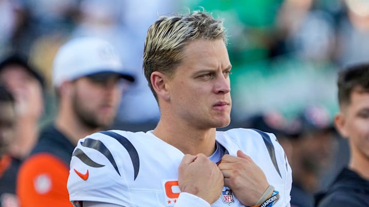 Cincinnati Bengals quarterback Joe Burrow stands on the sidelines during a game.