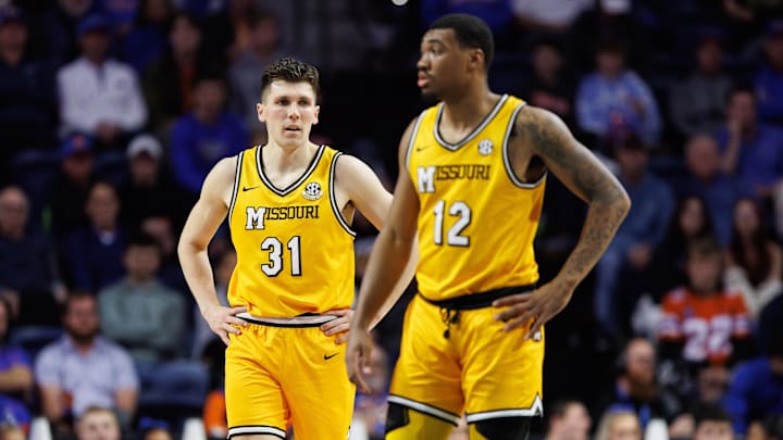 Jan 14, 2025; Gainesville, Florida, USA; Missouri Tigers guard Caleb Grill (31) looks on past Missouri Tigers guard Tony Perkins (12) against the Florida Gators during the first half at Exactech Arena at the Stephen C. O'Connell Center. Mandatory Credit: Matt Pendleton-Imagn Images