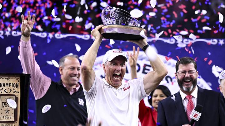 Dec 27, 2025; Houston, TX, USA; Houston Cougars head coach Willie Fritz hoists the champions trophy after the win over Louisiana State Tigers at NRG Stadium. Mandatory Credit: Maria Lysaker-Imagn Images Dec 27, 2025; Houston, TX, USA; Houston Cougars head coach Willie Fritz hoists the champions trophy after the win over Louisiana State Tigers at NRG Stadium. Mandatory Credit: Maria Lysaker-Imagn Images