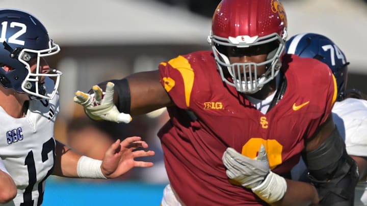 Sep 6, 2025; Los Angeles, California, USA;  Georgia Southern Eagles quarterback JC French IV (12) is pressured by Trojans defensive tackle Devan Thompkins (8) during the first half at United Airlines Field at the Los Angeles Memorial Coliseum. Mandatory Credit: Jayne Kamin-Oncea-Imagn Images