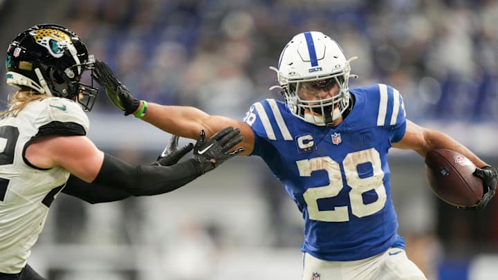 Indianapolis Colts running back Jonathan Taylor (28) pushes off Jacksonville Jaguars cornerback De'Antre Prince (24) as he rushes the ball Sunday, Jan. 5, 2025, during a game against the Jacksonville Jaguars at Lucas Oil Stadium in Indianapolis.
