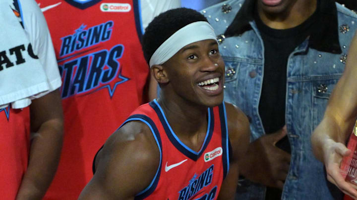 Feb 13, 2026; Inglewood, California, USA; Team Vince guard VJ Edgecombe (77) of the Philadelphia 76ers reacts with the MVP trophy after defeating Team Melo during an NBA All Star Rising Stars championship game at Intuit Dome. Mandatory Credit: Jayne Kamin-Oncea-Imagn Images Feb 13, 2026; Inglewood, California, USA; Team Vince guard VJ Edgecombe (77) of the Philadelphia 76ers reacts with the MVP trophy after defeating Team Melo during an NBA All Star Rising Stars championship game at Intuit Dome. Mandatory Credit: Jayne Kamin-Oncea-Imagn Images