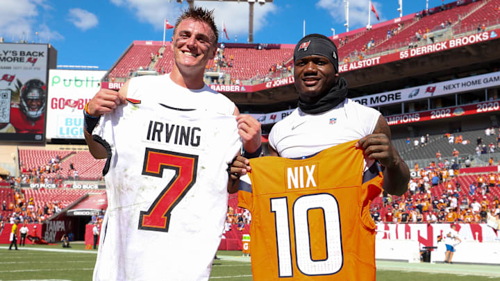 Sep 22, 2024; Tampa, Florida, USA; Tampa Bay Buccaneers running back Bucky Irving (7) and Denver Broncos quarterback Bo Nix (10) exchange jerseys after a game at Raymond James Stadium. 