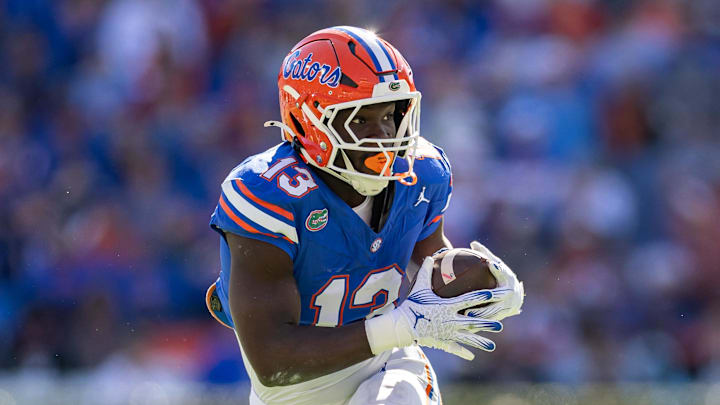 Nov 23, 2024; Gainesville, Florida, USA; Florida Gators running back Jadan Baugh (13) rushes with the ball against the Mississippi Rebels during the first half at Ben Hill Griffin Stadium. Mandatory Credit: Matt Pendleton-Imagn Images Nov 23, 2024; Gainesville, Florida, USA; Florida Gators running back Jadan Baugh (13) rushes with the ball against the Mississippi Rebels during the first half at Ben Hill Griffin Stadium. Mandatory Credit: Matt Pendleton-Imagn Images