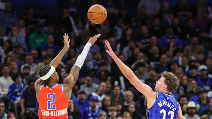 Feb 13, 2024; Orlando, Florida, USA; Oklahoma City Thunder guard Shai Gilgeous-Alexander (2) shoots the ball against Orlando Magic forward Franz Wagner (22) during the second quarter at Amway Center. Mandatory Credit: Mike Watters-Imagn Images