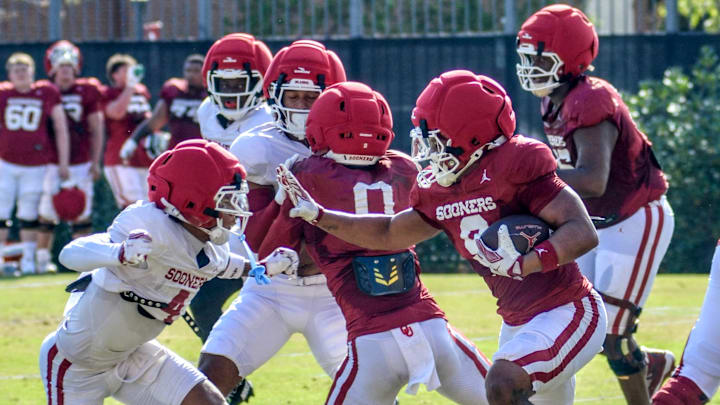 Oklahoma running back Lloyd Avant prepares to stiff arm a defender during practice.