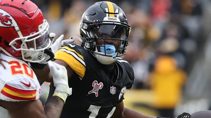 Dec 25, 2024; Pittsburgh, Pennsylvania, USA;  Pittsburgh Steelers wide receiver George Pickens (14) runs after a catch as Kansas City Chiefs safety Justin Reid (20) defends during the fourth quarter  at Acrisure Stadium. Mandatory Credit: Charles LeClaire-Imagn Images