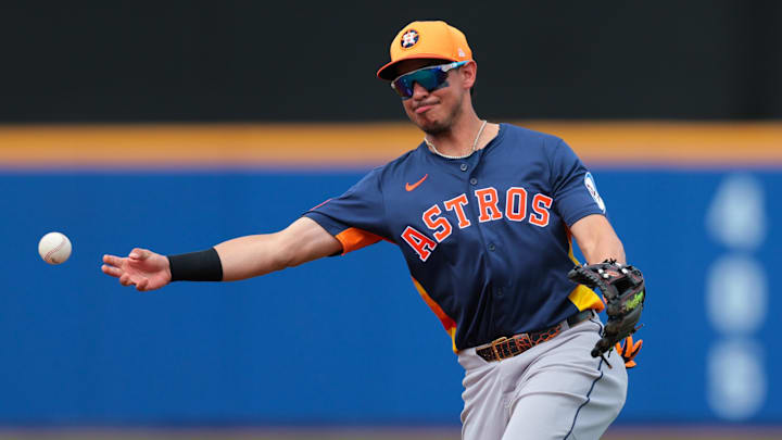 Feb 27, 2025; Port St. Lucie, Florida, USA; Houston Astros second baseman Mauricio Dubon (14) throws to first base and retires New York Mets third baseman Brett Baty (not pictured) during the fourth inning at Clover Park.