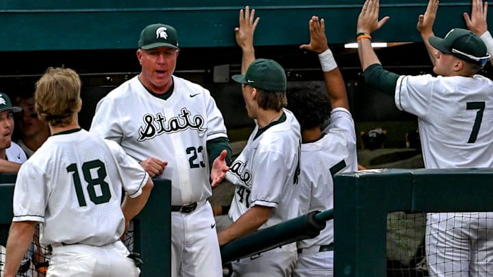 Michigan State's Noah Bright, left, celebrates his score with head coach Jake Boss Jr., center, and the dugout during the eighth inning in the game against Ohio State on Friday, April 18, 2025, at McLane Stadium in East Lansing.