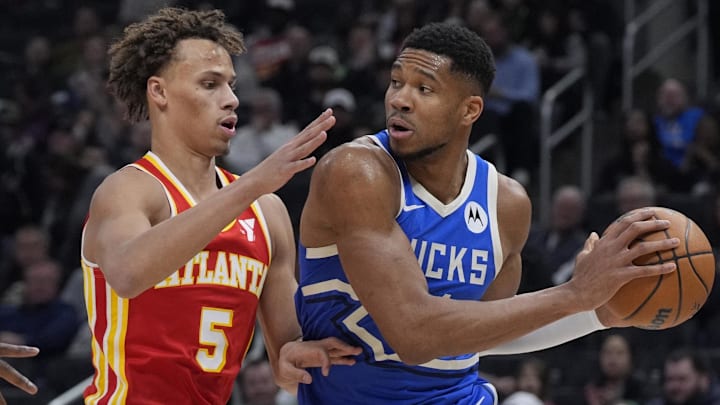 Dyson Daniels #5 of the Atlanta Hawks guards Giannis Antetkounmpo #34 of the Milwaukee Bucks