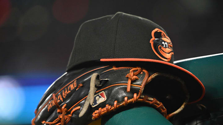 May 8, 2024; Washington, District of Columbia, USA; A Baltimore Orioles hat and glove rest on the dugout rail during a game against the Washington Nationals at Nationals Park. 