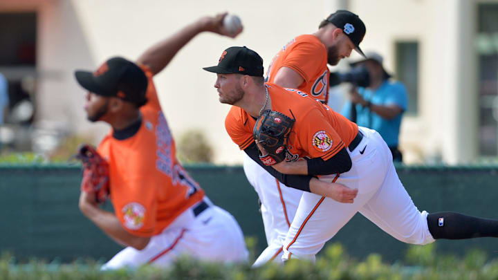 Orioles pitchers throw in the bullpen during spring training workouts at Ed Smith Stadium in Sarasota