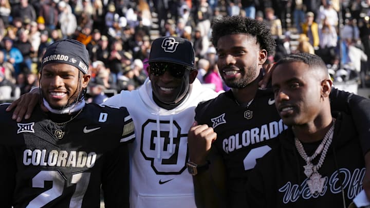 Nov 29, 2024; Boulder, Colorado, USA; Colorado Buffaloes safety Shilo Sanders (21) and head coach Deion Sanders and quarterback Shedeur Sanders (2) and social media producer Deion Sanders Jr. following the win against the Oklahoma State Cowboys at Folsom Field. Mandatory Credit: Ron Chenoy-Imagn Images