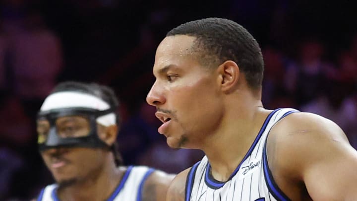 Apr 15, 2026; Philadelphia, Pennsylvania, USA; Philadelphia 76ers guard Vj Edgecombe (77) dribbles around Orlando Magic guard Desmond Bane (3) and guard Jalen Suggs (4) during the third quarter of a play-in round of the 2026 NBA Playoffs at Xfinity Mobile Arena. Mandatory Credit: Bill Streicher-Imagn Images