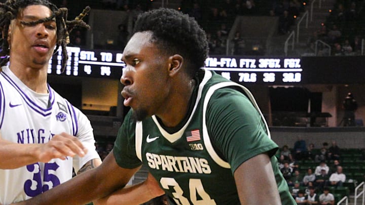 Nov 7, 2024; East Lansing, Michigan, USA; Michigan State Spartans forward Xavier Booker (34) drives past Niagara Purple Eagles forward AJ McBride (35) during the second half at Jack Breslin Student Events Center. Mandatory Credit: Dale Young-Imagn Images Nov 7, 2024; East Lansing, Michigan, USA; Michigan State Spartans forward Xavier Booker (34) drives past Niagara Purple Eagles forward AJ McBride (35) during the second half at Jack Breslin Student Events Center. Mandatory Credit: Dale Young-Imagn Images