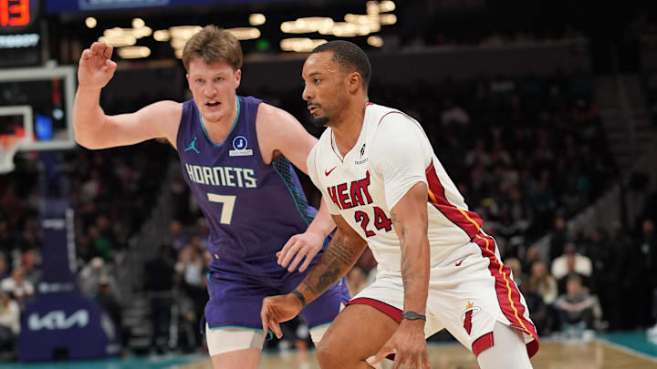 Mar 17, 2026; Charlotte, North Carolina, USA; Miami Heat guard Norman Powell (24) moves the ball against Charlotte Hornets guard Kon Knueppel (7) during the second half at Spectrum Center. Mandatory Credit: Jim Dedmon-Imagn Images