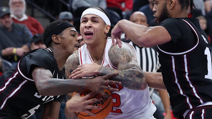 Utah Utes guard Terrence Brown is tied up by Mississippi State Bulldogs guard Shawn Jones Jr. and guard Jayden Epps during the second half at Delta Center.