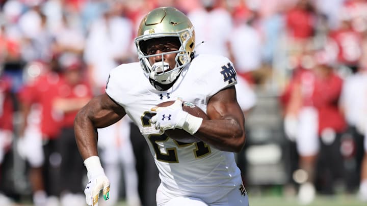 Sep 27, 2025; Fayetteville, Arkansas, USA; Notre Dame Fighting Irish running back Jadarian Price (24) rushes during the first quarter against the Arkansas Razorbacks at Donald W. Reynolds Razorback Stadium. Mandatory Credit: Nelson Chenault-Imagn Images