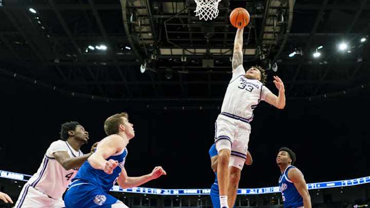 Dec 17, 2024; Kansas City, Missouri, USA; Kansas State Wildcats guard Coleman Hawkins (33) dunks the ball during the second half against the Drake Bulldogs at T-Mobile Center. Mandatory Credit: Jay Biggerstaff-Imagn Images
